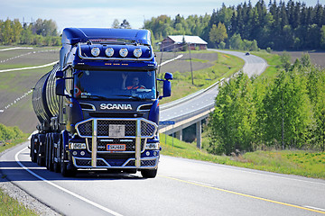 Image showing Dark Blue Scania R580 Trucking Uphill at Summer