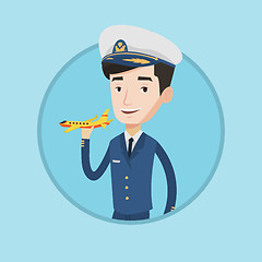 Image showing Cheerful airline pilot with model airplane.