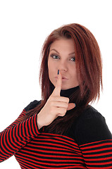 Image showing Young woman with finger over mouths.