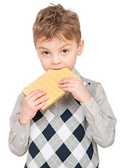 Image showing Little boy eating waffle