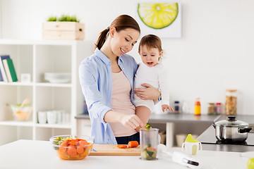 Image showing happy mother and baby cooking food at home kitchen