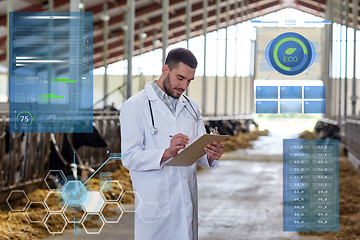 Image showing veterinarian with cows in cowshed on dairy farm