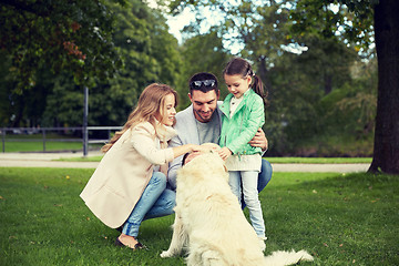 Image showing happy family with labrador retriever dog in park