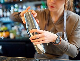 Image showing close up of bartender with cocktail shaker at bar