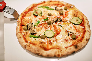 Image showing close up of pizza on peel at pizzeria