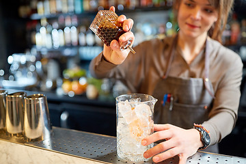 Image showing woman bartender preparing cocktail at bar