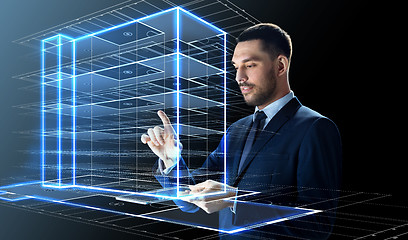 Image showing businessman with tablet pc and building hologram