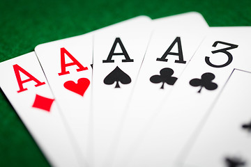 Image showing poker hand of playing cards on green casino cloth