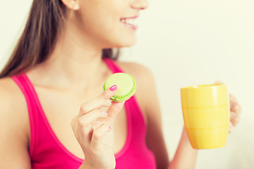 Image showing close up of happy woman or teen girl with cookie 