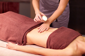 Image showing woman lying and having massage with hot oil at spa