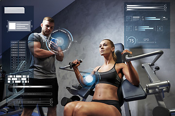 Image showing man and woman flexing muscles on gym machine