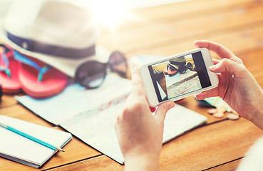 Image showing close up of woman with smartphone and travel stuff