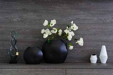 Image showing decorative vases and flowers at dark wooden shelf