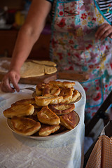 Image showing Grandmother bakes pies