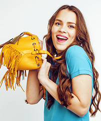 Image showing young pretty long hair woman happy smiling isolated on white background, wearing cute tiny fashion handbag, lifestyle people concept