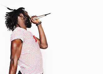 Image showing young handsome african american boy singing emotional with microphone isolated on white background, in motion gesturing smiling, lifestyle people concept 