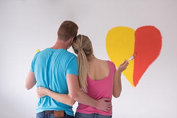 Image showing couple are painting a heart on the wall