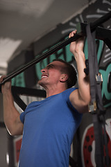 Image showing man doing pull ups