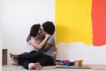 Image showing young multiethnic couple relaxing after painting