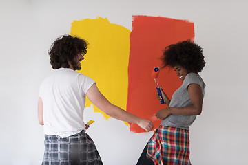 Image showing multiethnic couple painting interior wall