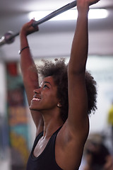 Image showing black woman lifting empty bar