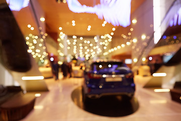 Image showing Blurred, defocused background of public event exhibition hall showing cars and automobiles