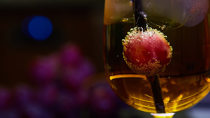 Image showing Grapes floating in champagne creating lots of bubbles