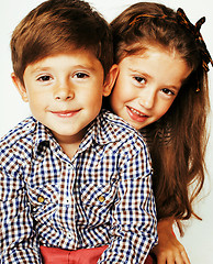 Image showing little cute boy and girl hugging playing on white background, ha