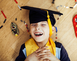 Image showing little cute preschooler boy among toys lego at home in graduate 