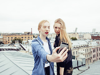 Image showing two cool blond real girls friends making selfie on roof top, lifestyle people concept, modern teens