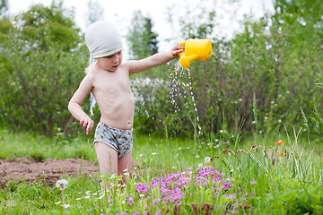 Image showing girl watering flowers