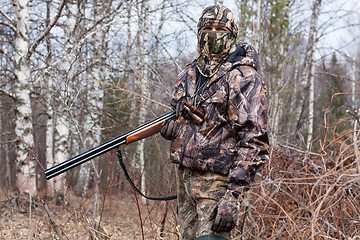 Image showing hunter in the camouflage with gun