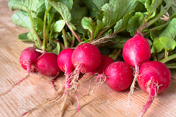 Image showing bunch of fresh radishes on the wooden table