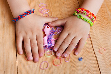 Image showing child hands with rubber bands