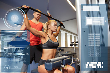 Image showing man and woman flexing muscles on gym machine