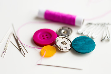 Image showing sewing buttons, needles, pins and thread spool