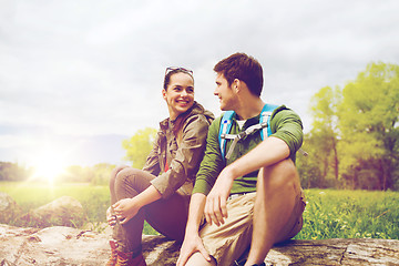 Image showing smiling couple with backpacks in nature