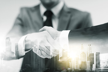 Image showing two businessmen shaking hands at office