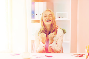 Image showing happy businesswoman celebrating success at office