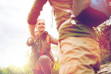 Image showing smiling couple with backpacks hiking