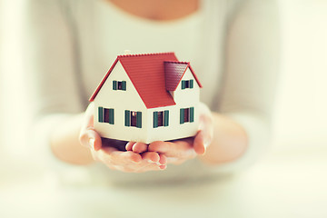 Image showing close up of hands holding house or home model