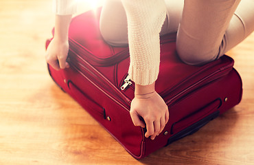 Image showing close up of woman packing travel bag for vacation