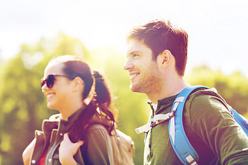 Image showing happy couple with backpacks hiking outdoors