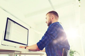 Image showing creative man or programmer with computer at office