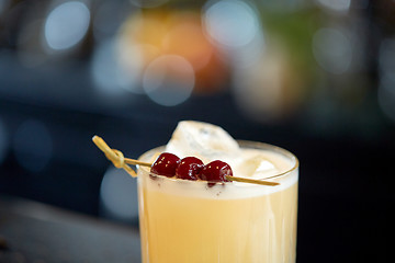 Image showing close up of cocktail glass with cherries at bar