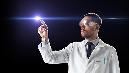 Image showing doctor or scientist in goggles with laser ray