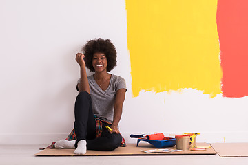 Image showing back female painter sitting on floor