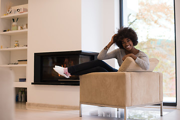 Image showing black woman in front of fireplace