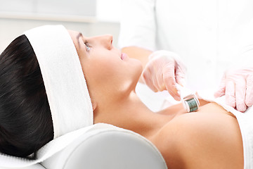 Image showing Beautician performs a needle mesotherapy treatment on a woman's face