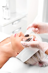 Image showing Sugar peeling, treatment in the beauty salon. Cleansing mask, a woman in the beauty salon.